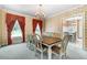 Formal dining area with an elegant chandelier, large windows, and carpet at 5150 Gentry Oaks Pl, St Cloud, FL 34772