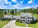 Elegant two-story house boasts mature trees, attached garage, and a well-maintained lawn at 5150 Gentry Oaks Pl, St Cloud, FL 34772