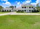An elegant estate featuring a circular drive, classic architecture and sprawling lawn at 5150 Gentry Oaks Pl, St Cloud, FL 34772