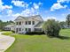 A stately home with a circular drive has mature trees and landscaping at 5150 Gentry Oaks Pl, St Cloud, FL 34772
