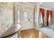 Inviting foyer featuring hardwood floors and a decorative glass front door with wallpaper at 5150 Gentry Oaks Pl, St Cloud, FL 34772