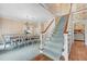 Entry hall featuring wood and carpeted stairs, dining area and stone fireplace at 5150 Gentry Oaks Pl, St Cloud, FL 34772