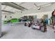 Spacious garage featuring epoxy floors, plenty of room for vehicles and recreational equipment, with ample storage at 5150 Gentry Oaks Pl, St Cloud, FL 34772