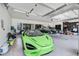 Spacious garage with a modern green sports car, jet skis and ample space at 5150 Gentry Oaks Pl, St Cloud, FL 34772