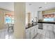 Bright kitchen with granite countertops, white cabinets, and stainless steel appliances at 5150 Gentry Oaks Pl, St Cloud, FL 34772