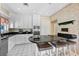 Kitchen with white cabinets, black countertops, stainless appliances, and breakfast bar seating at 5150 Gentry Oaks Pl, St Cloud, FL 34772