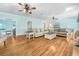 Spacious living room with hardwood floors, comfortable seating, and seamless transitions to other rooms at 5150 Gentry Oaks Pl, St Cloud, FL 34772