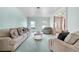 Spacious living room with plush seating, large windows, and classic interior design at 5150 Gentry Oaks Pl, St Cloud, FL 34772