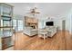 Open living room with fireplace, hardwood floors, and comfortable seating area at 5150 Gentry Oaks Pl, St Cloud, FL 34772