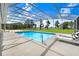 Cool off in this pool, screened from the elements, with seating and nature views at 5150 Gentry Oaks Pl, St Cloud, FL 34772