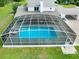 Aerial view of the screened pool with chairs in the backyard of the home at 5150 Gentry Oaks Pl, St Cloud, FL 34772
