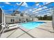 Stunning screened-in pool with lounge chairs offers a refreshing escape in this luxurious backyard setting at 5150 Gentry Oaks Pl, St Cloud, FL 34772