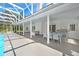 Inviting outdoor space featuring a large covered patio with an outdoor kitchen and ample seating at 5150 Gentry Oaks Pl, St Cloud, FL 34772