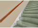 Carpeted staircase with wooden handrail and light colored walls at 5150 Gentry Oaks Pl, St Cloud, FL 34772
