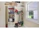 Utility storage area with built-in shelving and window for natural light at 5150 Gentry Oaks Pl, St Cloud, FL 34772