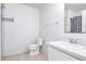 Clean bathroom with a white toilet, sink, vanity, and shower-tub combination with a patterned curtain at 56 Levee Ln, Ormond Beach, FL 32174