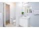 A well-lit bathroom with a walk-in closet, white cabinets, and a ceramic tile floor at 56 Levee Ln, Ormond Beach, FL 32174