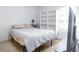 Cozy bedroom featuring a bed, shelving unit, and a window for natural light at 56 Levee Ln, Ormond Beach, FL 32174