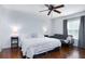 Comfortable bedroom with hardwood floors, a ceiling fan, a large window, and a cozy seating area at 56 Levee Ln, Ormond Beach, FL 32174