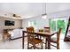 Bright dining area with wooden table, pendant lighting, and sliding door access to outdoor space at 56 Levee Ln, Ormond Beach, FL 32174