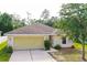 Charming one-story home featuring an attached two-car garage and a well-maintained, landscaped front yard at 56 Levee Ln, Ormond Beach, FL 32174