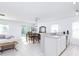 Modern kitchen with stainless steel appliances, light countertops, and an adjacent living/dining space at 56 Levee Ln, Ormond Beach, FL 32174