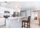 Well-lit kitchen featuring white cabinets, stainless steel appliances, and a breakfast bar with seating at 56 Levee Ln, Ormond Beach, FL 32174