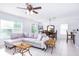 Open-concept living space with tiled floors, a plush sectional sofa, and a dining area with natural light at 56 Levee Ln, Ormond Beach, FL 32174