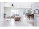 Spacious open-concept living space with tiled floors, comfortable sofa, and an adjacent dining area bathed in sunlight at 56 Levee Ln, Ormond Beach, FL 32174