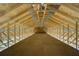 Unfinished attic space with exposed rafters and wooden beams at 6479 Apple St, St Cloud, FL 34771