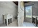 Unfinished bathroom with basic sink, toilet, and exposed block walls, and a window at 6479 Apple St, St Cloud, FL 34771