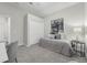 Bedroom featuring carpet floors, a closet, and a gray chair at 6479 Apple St, St Cloud, FL 34771