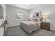 Bedroom with a large window, plush carpet, and stylish decor at 6479 Apple St, St Cloud, FL 34771