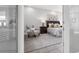 Comfortable bedroom featuring soft carpet, a sitting area and access to the bathroom at 6479 Apple St, St Cloud, FL 34771