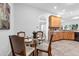 Eat-in-kitchen dining area, featuring a round glass table and seating for four at 6479 Apple St, St Cloud, FL 34771