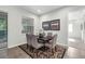 Dining room features a wooden table and seating for six with decorative rug and neutral wall paint at 6479 Apple St, St Cloud, FL 34771