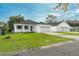 Charming home exterior with a lush lawn and a convenient three-car garage for all your vehicles at 6479 Apple St, St Cloud, FL 34771