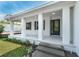 Inviting covered front porch with decorative columns and beautiful entry door, enhancing the home's curb appeal at 6479 Apple St, St Cloud, FL 34771