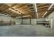 Large garage space with multiple overhead doors, workbench area, and shelving at 6479 Apple St, St Cloud, FL 34771