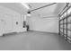 Spacious garage with a door, concrete floors, and water heater at 6479 Apple St, St Cloud, FL 34771