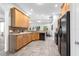 Traditional kitchen with light wood cabinetry, tile countertops, and black appliances at 6479 Apple St, St Cloud, FL 34771