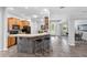 Kitchen breakfast bar with tile countertops and bar stool seating overlooking the open floor plan at 6479 Apple St, St Cloud, FL 34771