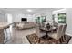 Open living and dining area with elegant decor, a modern table setting, and a cozy atmosphere for entertaining at 6479 Apple St, St Cloud, FL 34771