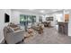 Spacious living room with a sliding glass door to the backyard, comfortable seating, and stylish decor at 6479 Apple St, St Cloud, FL 34771