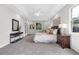 Spacious main bedroom with a tray ceiling, ample lighting, and ensuite bathroom at 6479 Apple St, St Cloud, FL 34771