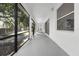 Screened patio featuring a gray floor, windows, and a view of trees at 6479 Apple St, St Cloud, FL 34771