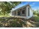 View of the back of the house featuring a screened in sunroom with a concrete patio and yard at 6479 Apple St, St Cloud, FL 34771