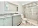 Bathroom with modern sink, vanity, and shower with glass door at 713 Wood Ln, Kissimmee, FL 34759