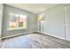 Bedroom with hardwood floors, neutral walls, and view of the backyard at 713 Wood Ln, Kissimmee, FL 34759