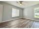 Bright bedroom featuring natural light, hardwood floors, and neutral walls at 713 Wood Ln, Kissimmee, FL 34759